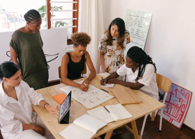 diverse group of women analysing reports and planning together